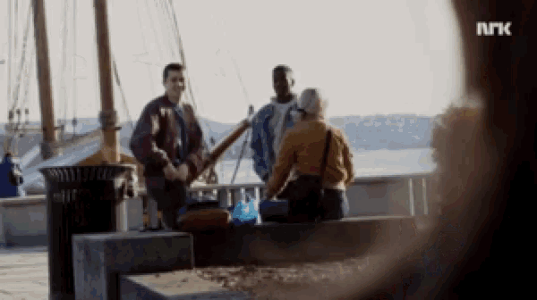 a blurred image of a group of people with the letters " nrk " on the bottom right