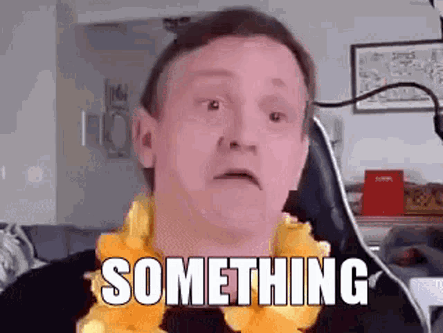 a man wearing a lei is sitting in a chair with the words something written on his face .