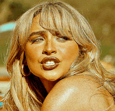 a close up of a woman 's face with a slight smile on her face