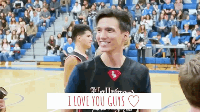 a basketball player smiles while wearing a shirt that says hollywood