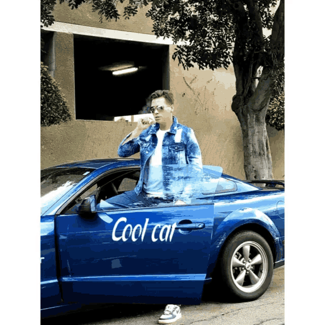 a man is standing next to a blue car that says cool car on the door