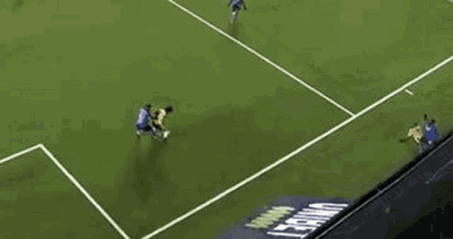 a group of soccer players are playing a game on a soccer field .