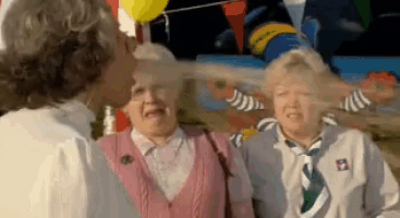 a man kisses a woman on the cheek while another woman laughs