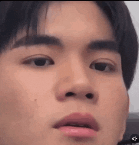 a close up of a man 's face with his mouth open .