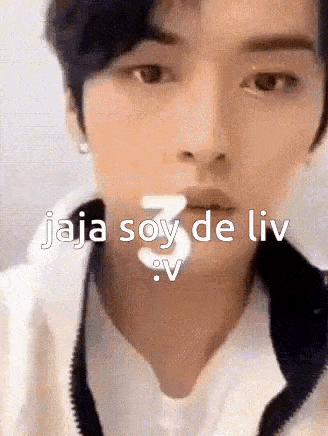 a close up of a young man 's face with the words `` jaja soy de liv '' written on it .