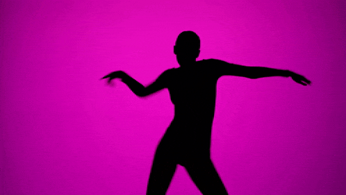 a silhouette of a woman dancing in front of a purple background
