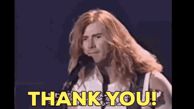 a man with long hair is singing into a microphone and the words thank you are above him