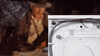 a man in a cowboy hat is looking at a washer and dryer