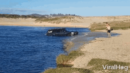 a car is stuck in the water and the word viralhog is on the bottom of the picture