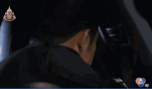 a man and a woman are looking into each other 's eyes with the number 7 on the bottom left