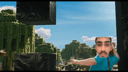 a man in a blue shirt is standing in front of a video game scene