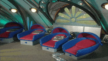 a row of blue chairs with red cushions in a room