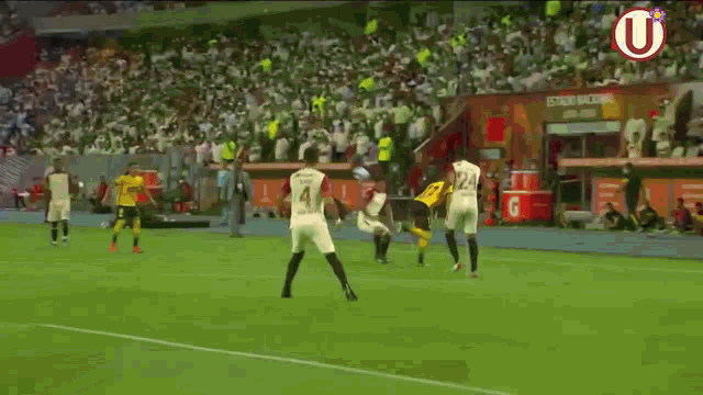 a soccer game is being played in a stadium with a sign that says estadio nacional on it