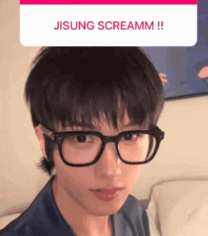 a close up of a person wearing glasses with the words jisung screamm written above them