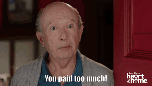 an older man is standing in front of a red door and says " you paid too much "