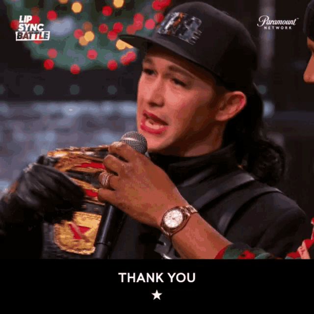 a man holding a microphone says thank you
