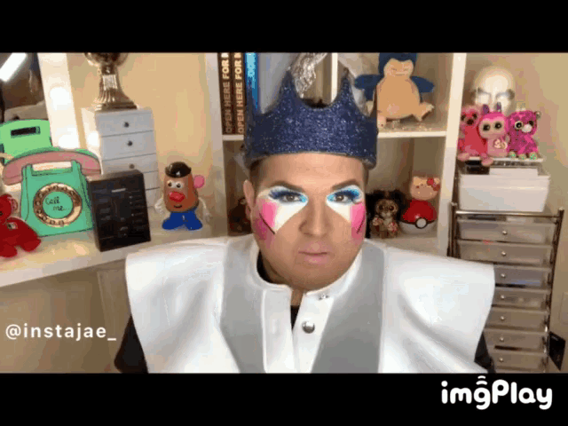 a man with a crown on his head has a sticker on his face that says instajae_