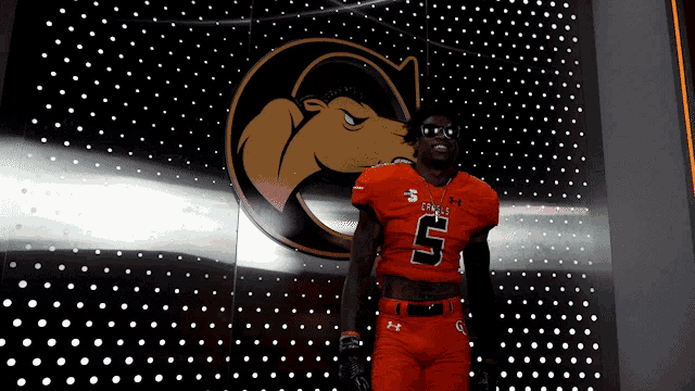 a football player wearing an orange uniform with the number 5
