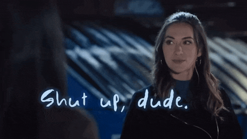 a woman is talking to another woman with the words shut up dude behind her