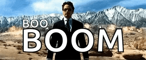a man in a suit and tie stands in front of a mountain with the words boo boom written above him