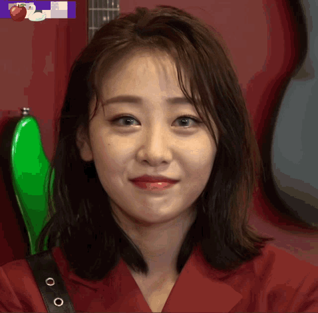 a close up of a woman 's face in front of a guitar