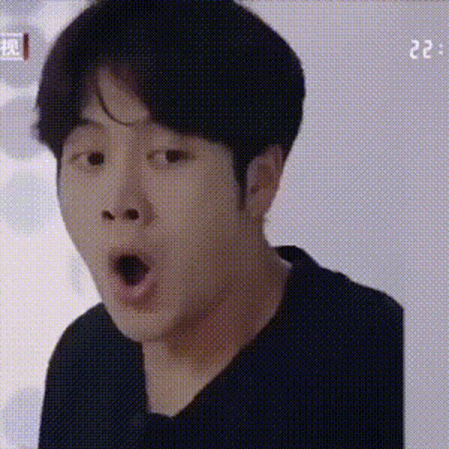 a man is making a surprised face with his mouth open .