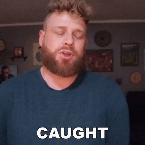 a man with a beard says " my attention " in a living room