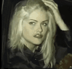 a close up of a woman 's face with blonde hair .