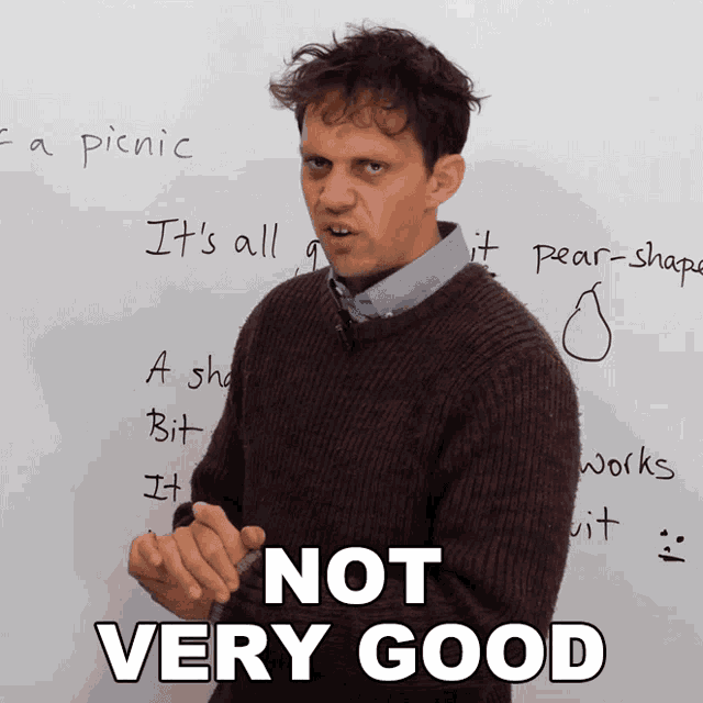 a man standing in front of a white board with the words " not very good " written on it
