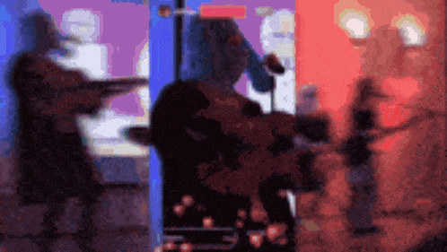 a blurry picture of a man playing a guitar