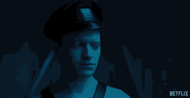a man wearing a hat and a netflix logo