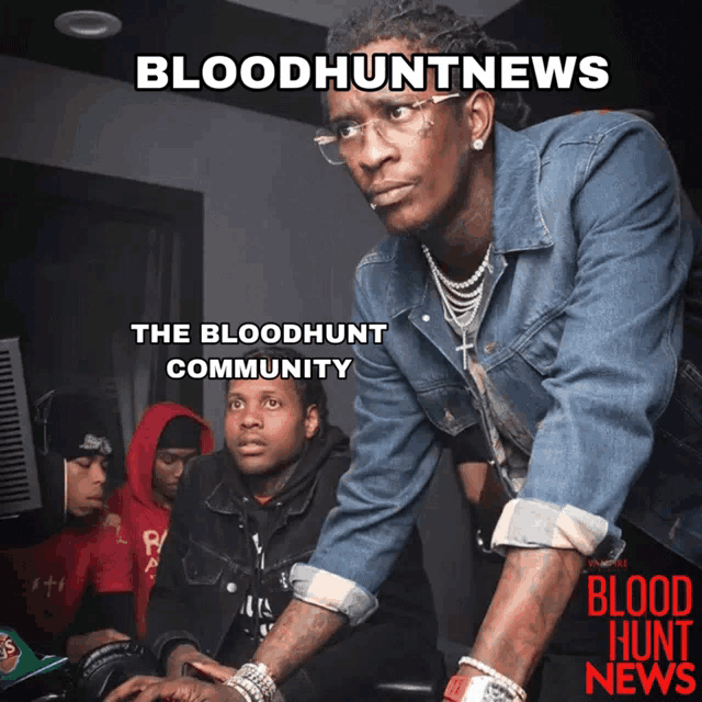 a man in a denim jacket is looking at a computer screen with the words bloodhuntnews on the bottom
