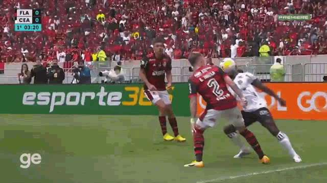 a soccer game is being played in front of a esporte 3l banner