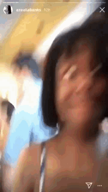 a blurry picture of a person 's face with the words azealiabanks 12h on the bottom