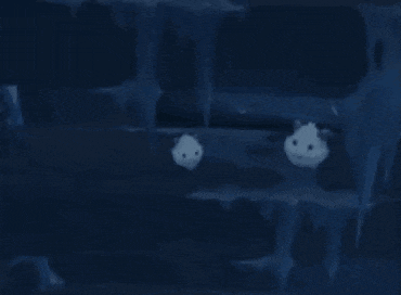 two ghosts are floating in the water in a cave .
