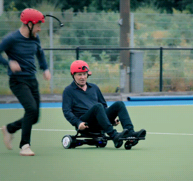 a man wearing a red helmet rides a hover board