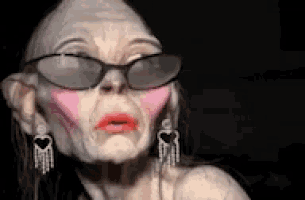 a woman with glasses and pink lipstick on her face