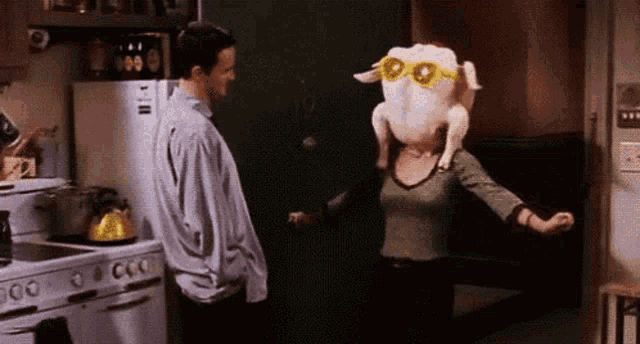 a woman wearing sunglasses and a turkey head is dancing in a kitchen .