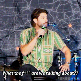 a man speaking into a microphone with the words what the f are we talking about on the bottom