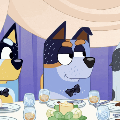 a dog with a bow tie sits at a table