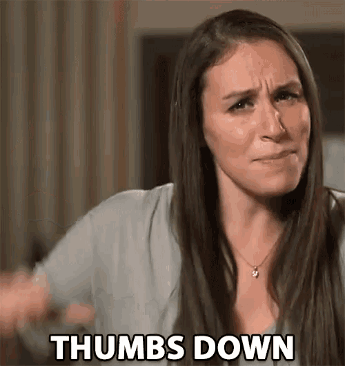 a woman is making a funny face and saying thumbs down