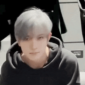 a close up of a young man wearing a black hoodie .