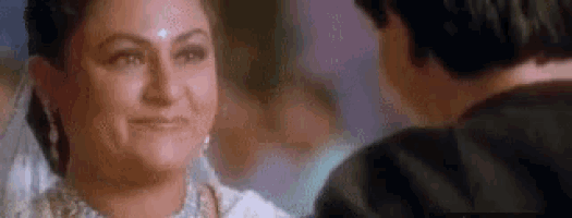 a woman is smiling at a man while looking at him in a blurry photo .