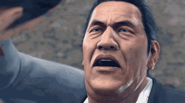 a man in a suit is making a funny face with his mouth open