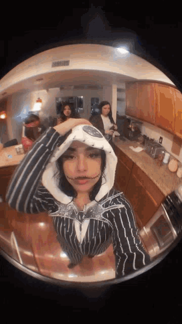 a girl in a nightmare before christmas costume is taking a selfie