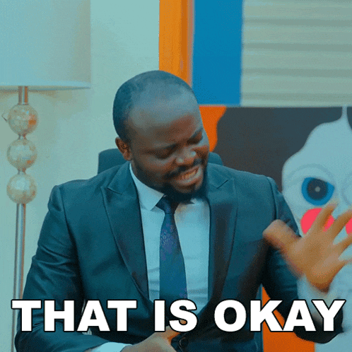 a man in a suit and tie says " that is okay " in white letters