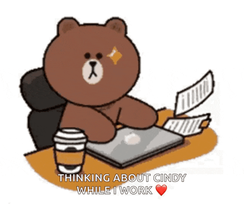 a brown bear is sitting at a desk with papers and a cup of coffee