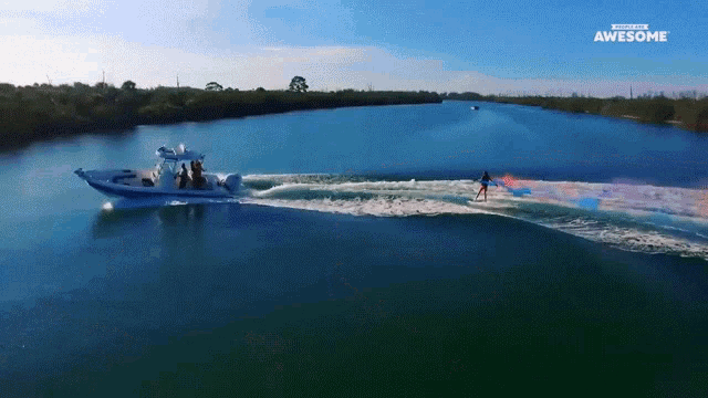 a boat is being towed by a person on a surfboard and the words awesome are on the bottom right