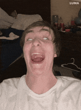 a man is making a funny face in front of a luma ad