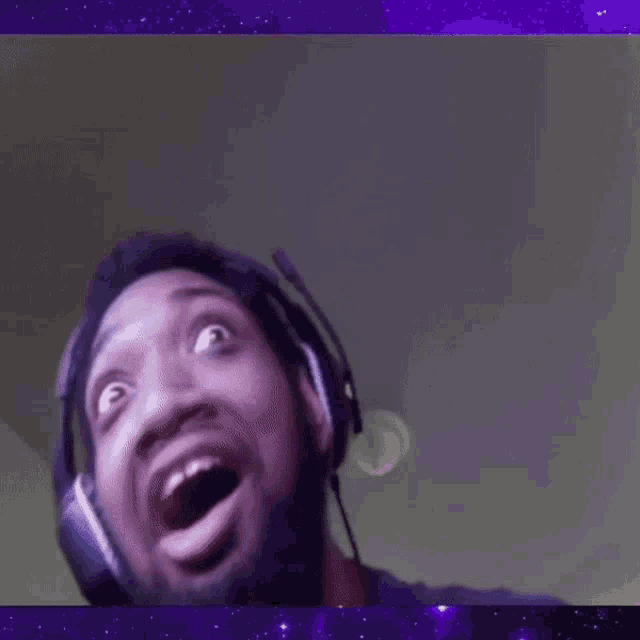 a man wearing headphones with his mouth open